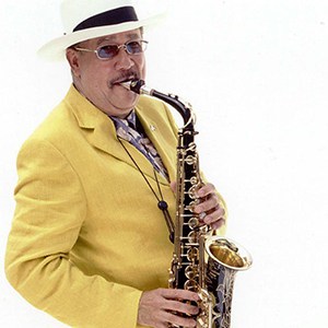 Paquito D'Rivera in yellow jacket playing saxophone