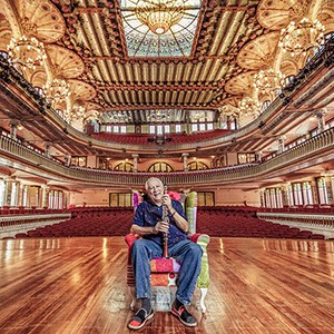 Paquito D'Rivera on stage in an auditorium