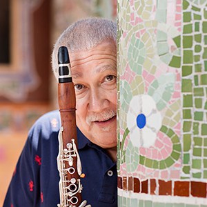 Paquito D'Rivera with clarinet next to column