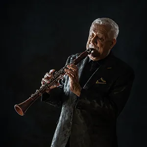 Paquito D'Rivera in black jacket with side light effect